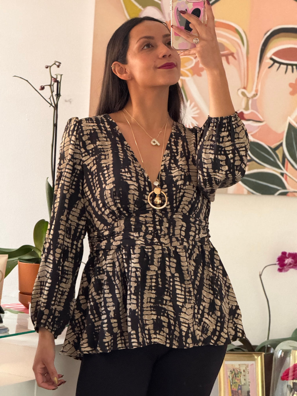 Blusa corte peplum estampada manga larga